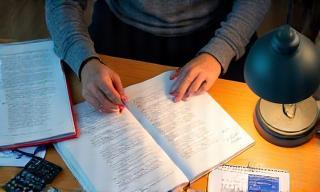 Exam preparation materials and tutor working with student